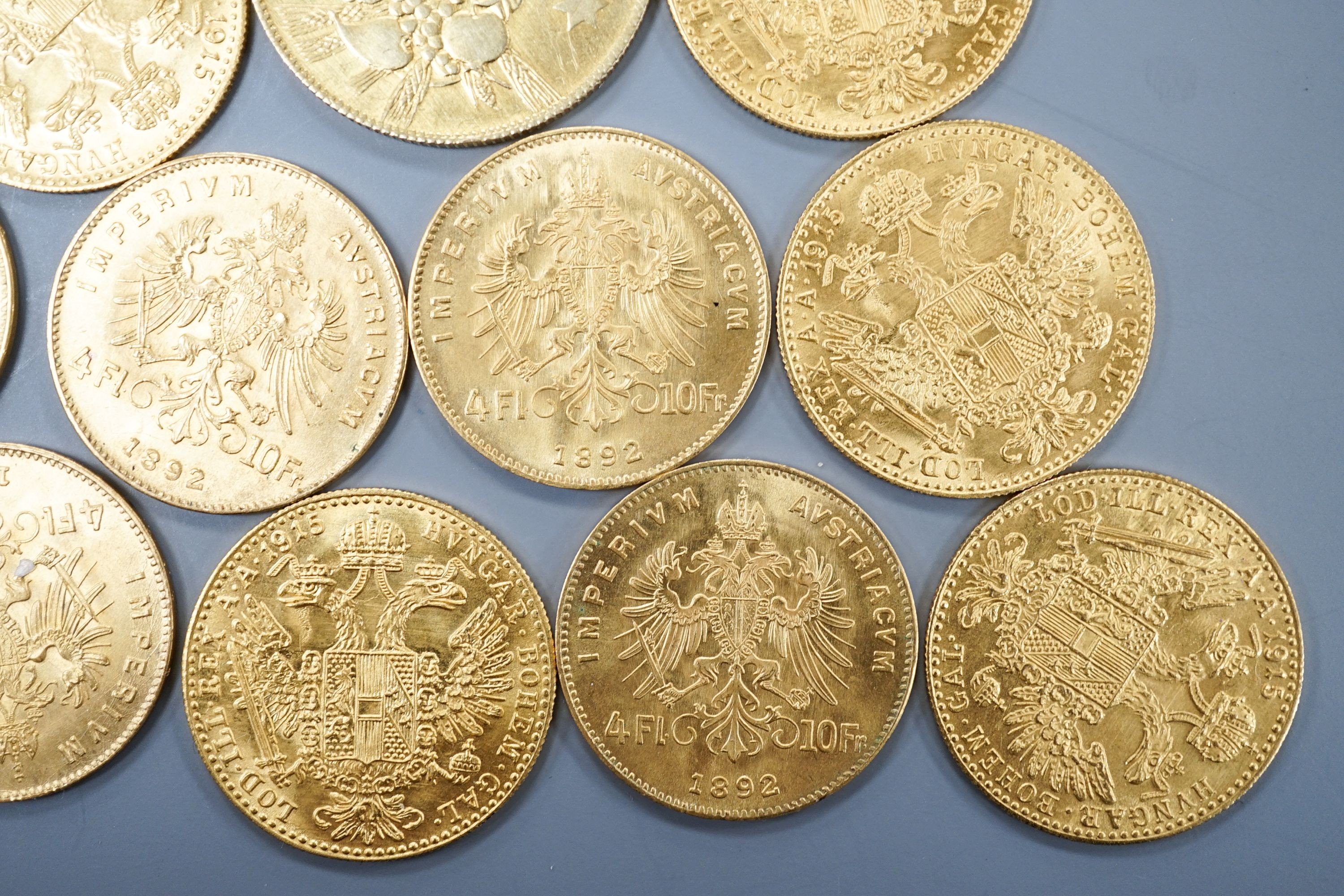 Ten Austrian gold Ducats (re-strikes) and an Italian 750 yellow metal 'I Star Lina de Amicizia'